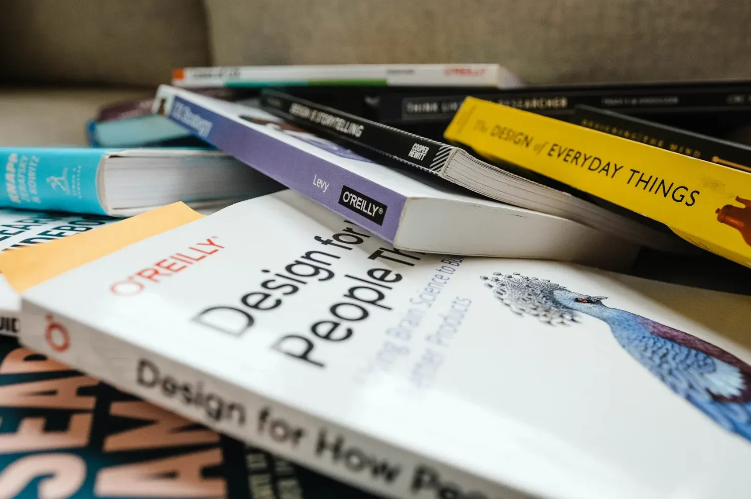 A pile of design books including The Design of Everyday Things