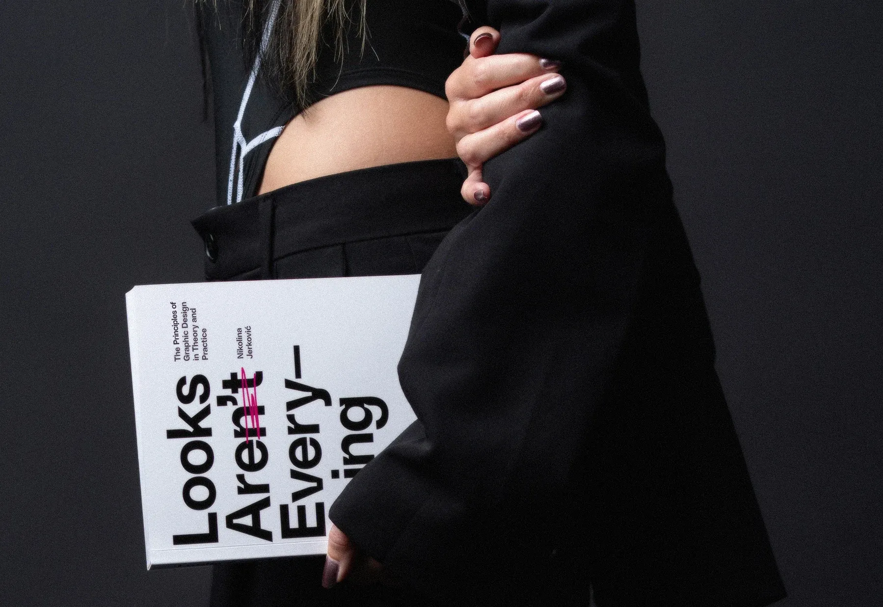 Nikolina holding a copy of Looks Aren’t Everything